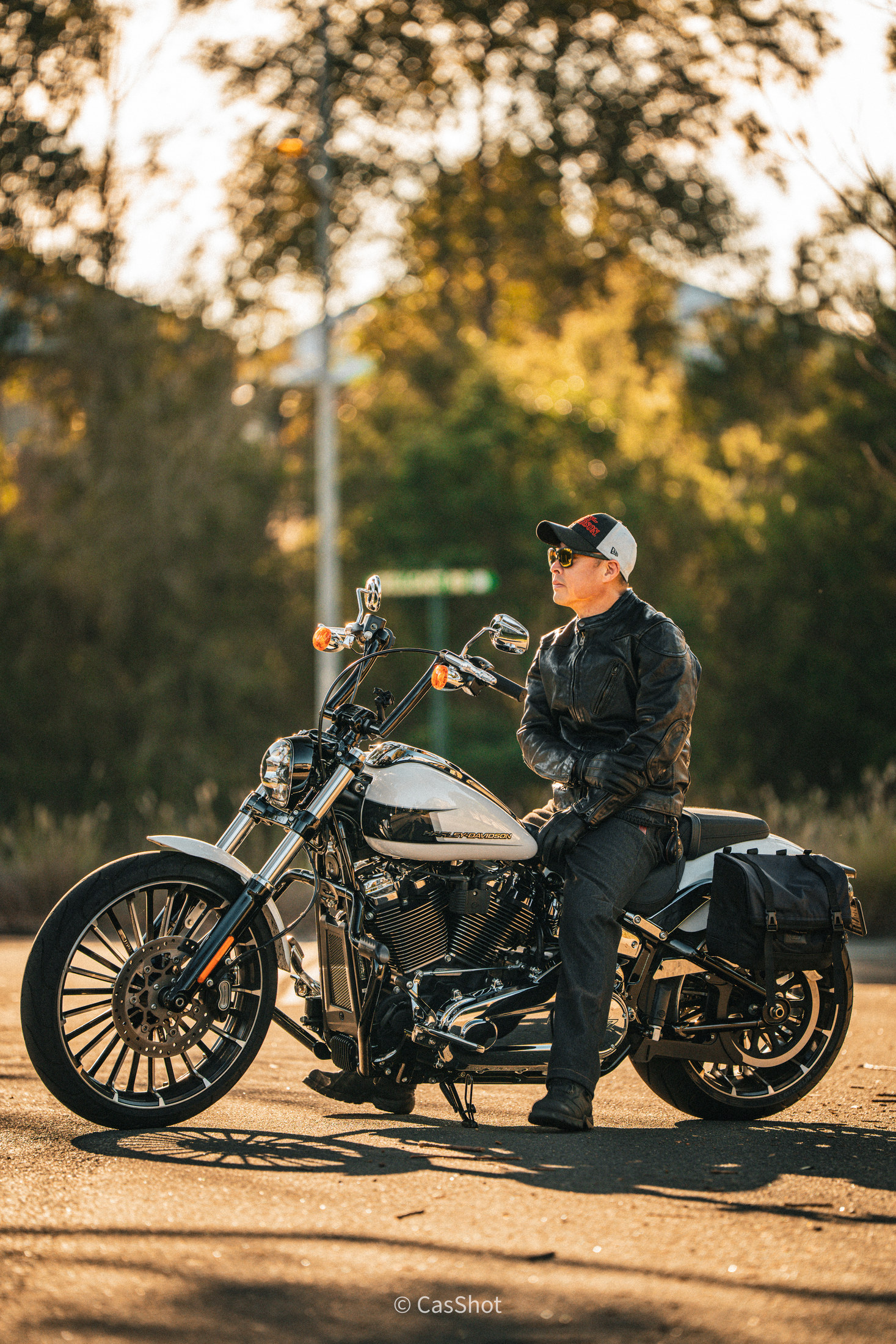Motorcycle portrait for a client, photographed by Cas Gao in warm evening light beneath trees